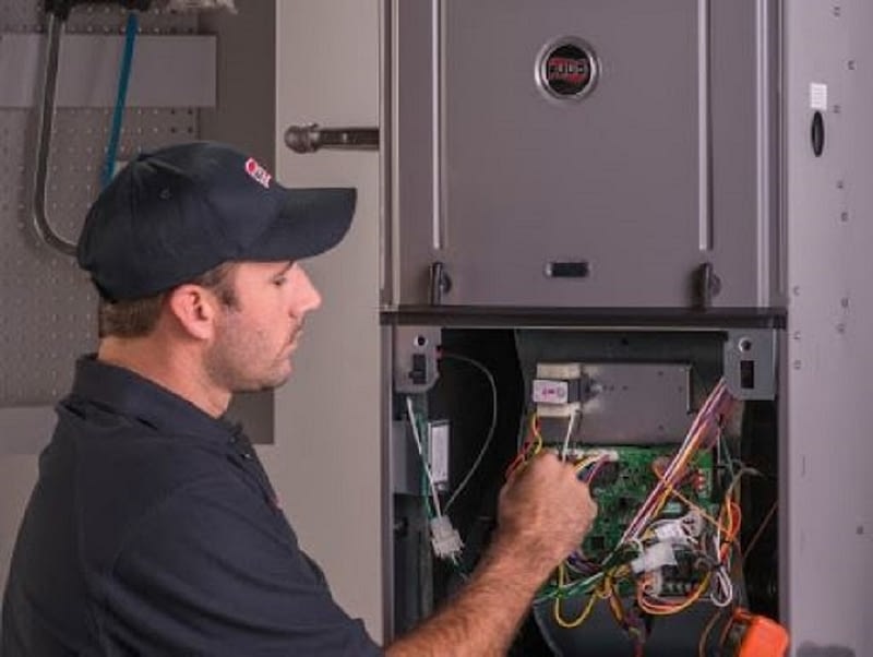 Technician repairing A/C unit